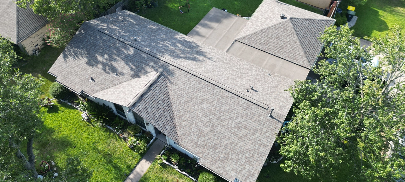 Aerial view of a single-story home with a new tan shingle roof