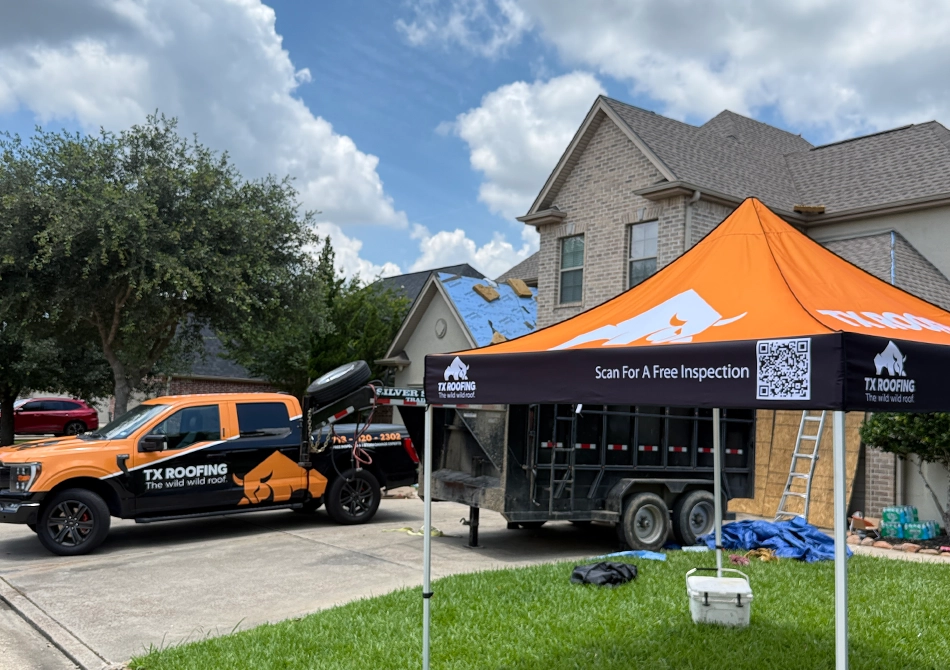 TX Roofing truck and free inspection tent outside a brick home during a roof repair